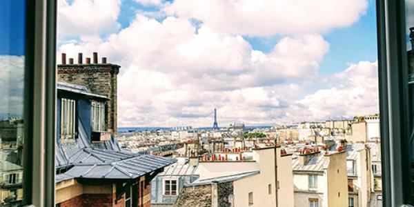 Photo from a study abroad trip shows the rooftops of Paris with the Eiffel Tower barely visible in the distance.