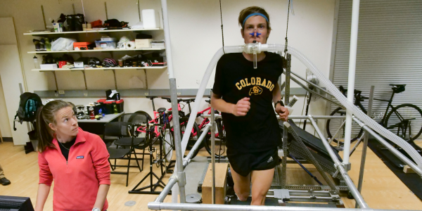 A student runs on a treadmill wearing a breathing mask that tracks his oxygen intake.
