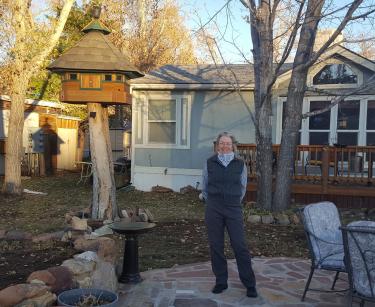 Peggy Kuhn in front of her manufactured home.