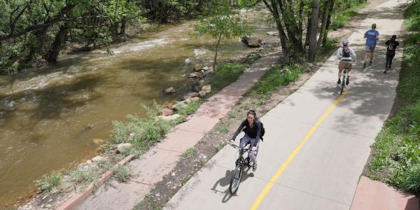 Bicyclists and joggers on Boulder Creek path