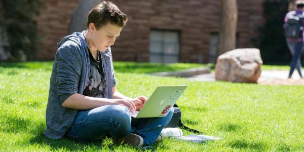 Student on their laptop outside