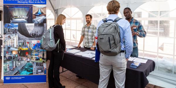 Students talking to employers at a career fair