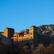 Campus building with Flatirons in the background