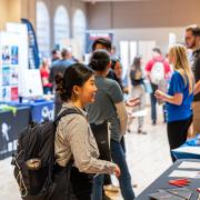 Students visiting booths at a career fair on campus