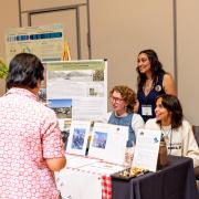 Campus community members visit a booth at the sustainability summit