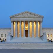 The United States Supreme Court building at dusk. 