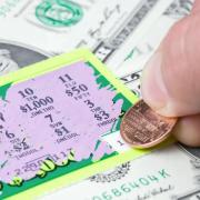 Person scratching lottery ticket